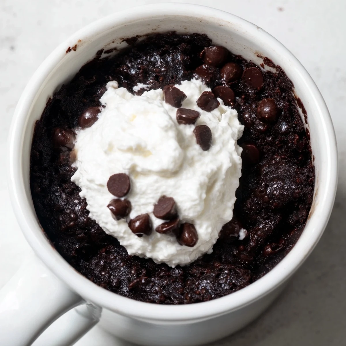 Instant gratification: a single-serve chocolate mug cake, warm and decadent, ready in minutes.