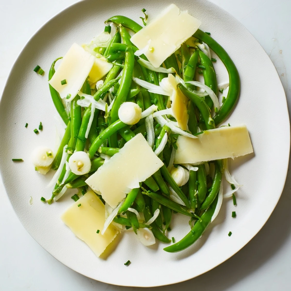 Beautifully plated English Ivy salad, with vibrant green snap peas and cheddar cheese.
