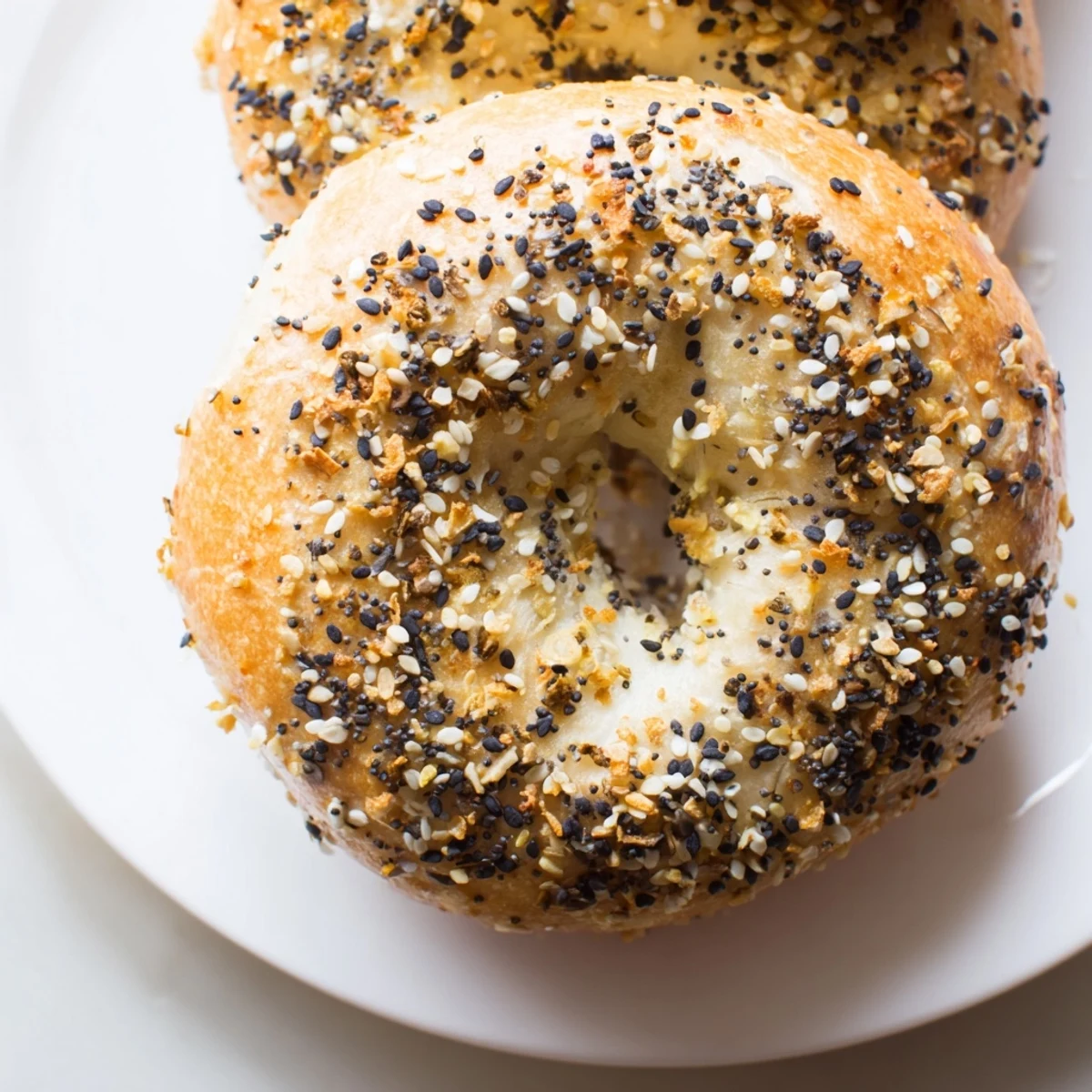 Fluffy Everything Bagel Yogurt Bagels, golden brown and sprinkled with savory seasoning, fresh from the oven.