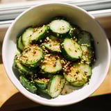 Close-up of a jar of Shake Shake Garlic Cucumbers being shaken to coat the crunchy slices in the savory garlic mixture.  