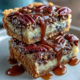 Kentucky Derby Pecan Pie Bars with Bourbon Glaze are drizzled with rich glaze and topped with crunchy pecans.