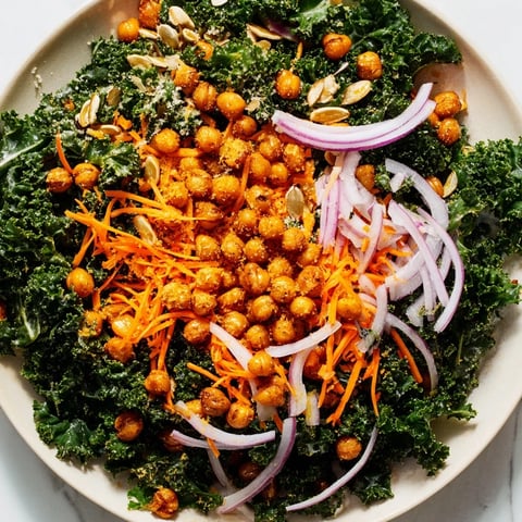 Crispy roasted chickpeas sit atop vibrant kale in this healthy Kale Salad.