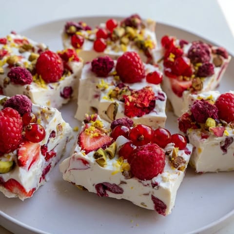 A close-up view of frozen yogurt bark showcasing fresh berries and a creamy, inviting texture.
