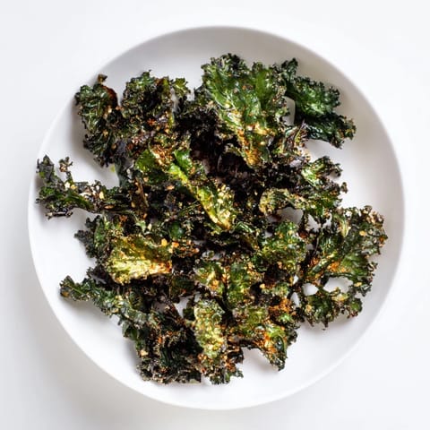 Golden, crispy kale chips baked until perfectly crunchy, a healthy and delightful snack.