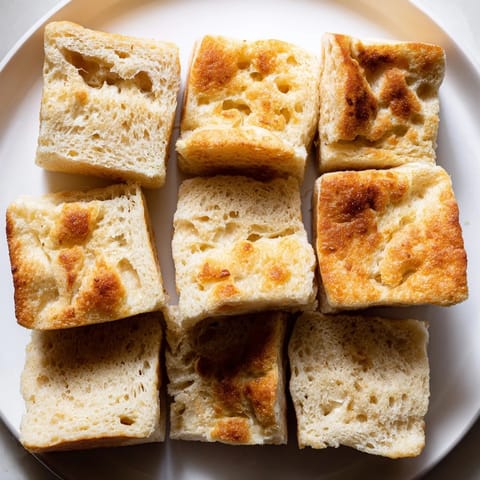 Warm, toasted sheet pan English muffins ready to be split, delicious breakfast or brunch idea.