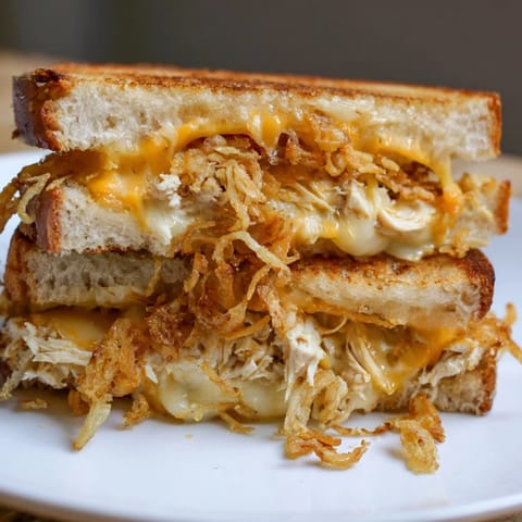 Savory Crispy Shallot Chicken Grilled Cheese with crunchy shallots, cheese pulls, ready to eat.