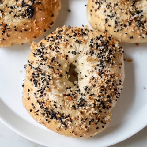 A close-up of warm Everything Bagel Yogurt Bagels, ready to be slathered with cream cheese or enjoyed plain.