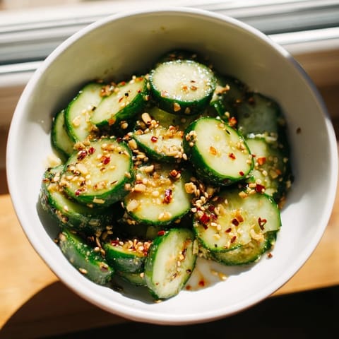 Close-up of a jar of Shake Shake Garlic Cucumbers being shaken to coat the crunchy slices in the savory garlic mixture.  