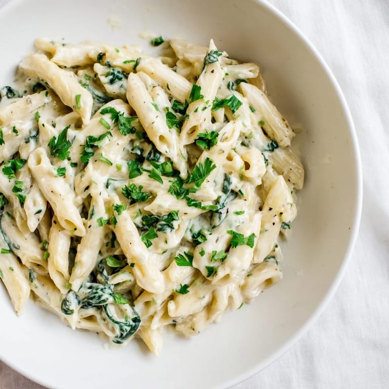Enjoy a spoonful of The Magic Casserole: Creamy Spinach Pasta with a rich, cheesy, and irresistible flavor.