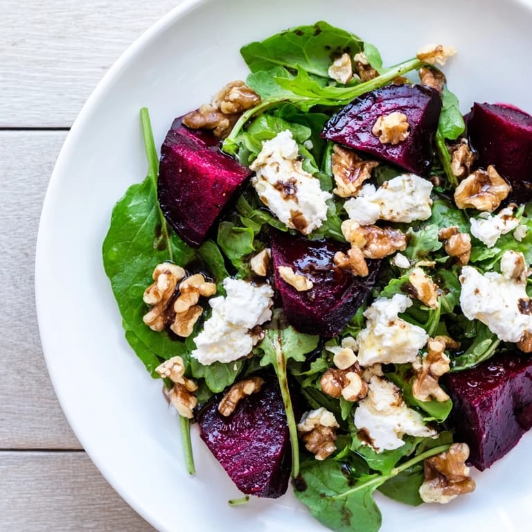 Tangy balsamic dressing drizzled over a beautiful, colorful beet and goat cheese salad creation.