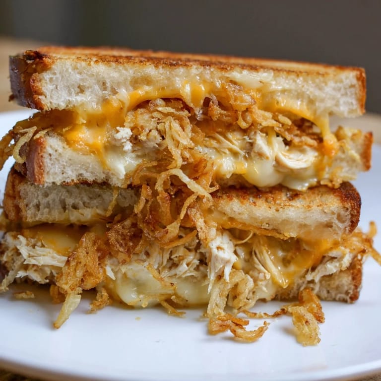 Savory Crispy Shallot Chicken Grilled Cheese with crunchy shallots, cheese pulls, ready to eat.