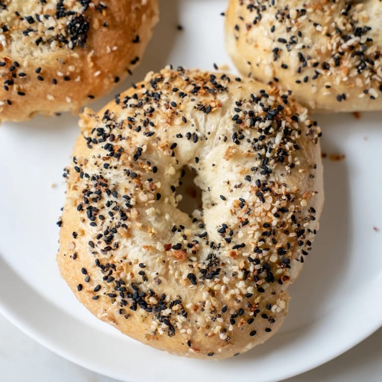 A close-up of warm Everything Bagel Yogurt Bagels, ready to be slathered with cream cheese or enjoyed plain.