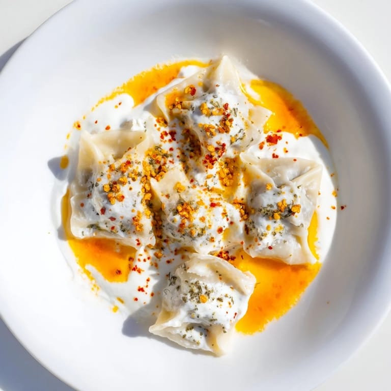 Tender, homemade Turkish cheesy manti dumplings, showcasing a delicious cheese filling and vibrant presentation.